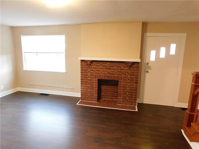 unfurnished living room featuring dark hardwood / wood-style floors