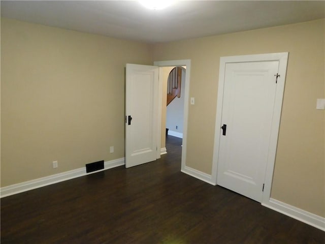 empty room featuring dark hardwood / wood-style flooring