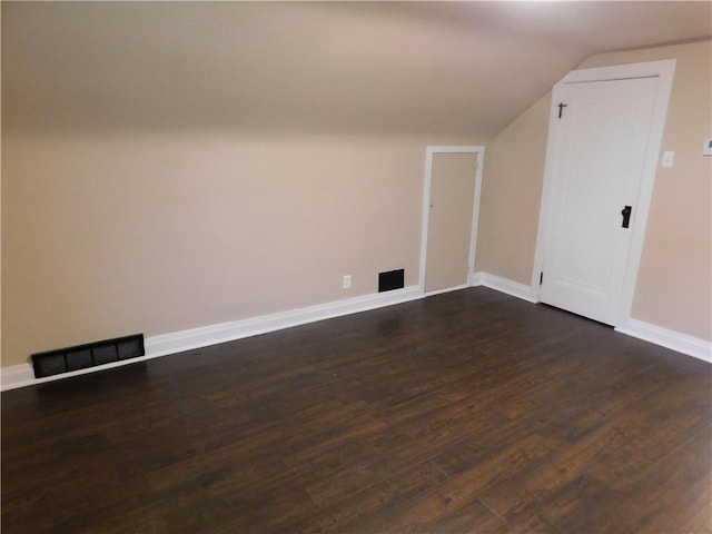 additional living space with dark hardwood / wood-style floors and lofted ceiling