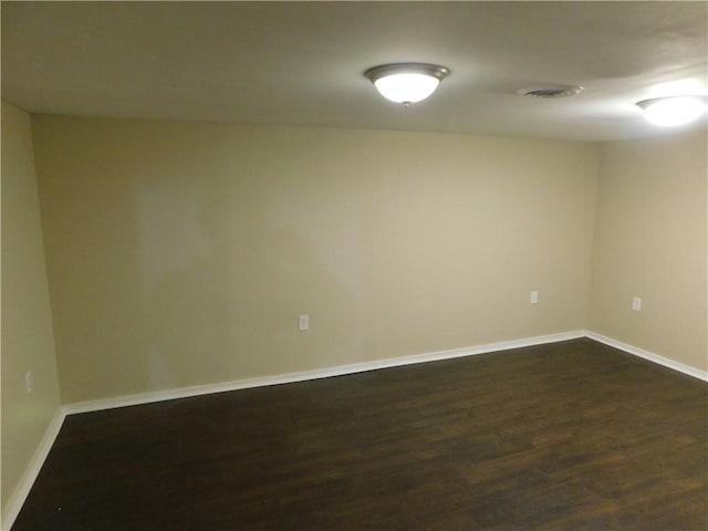 unfurnished room with dark hardwood / wood-style flooring