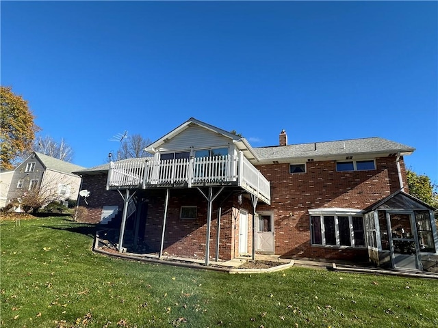 back of house featuring a yard and a wooden deck