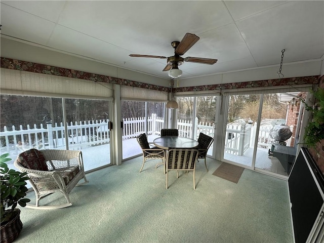 sunroom / solarium featuring ceiling fan