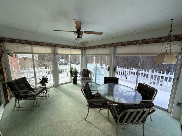 sunroom / solarium featuring a wealth of natural light and ceiling fan