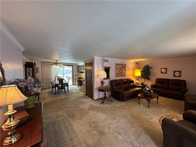 living room with carpet flooring, ceiling fan, and ornamental molding