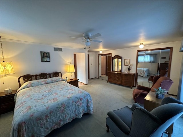 bedroom featuring a closet, ceiling fan, crown molding, and light carpet