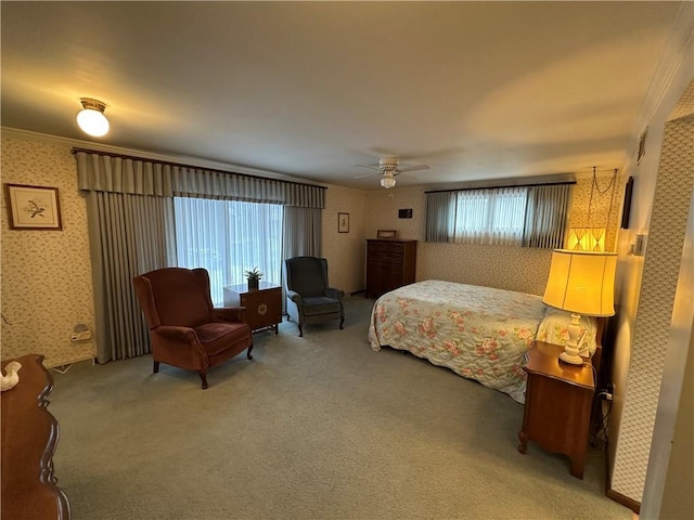 bedroom featuring ceiling fan, carpet, and ornamental molding