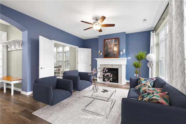 living room with a tile fireplace, ceiling fan, and hardwood / wood-style flooring