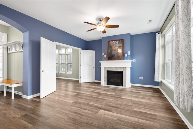 unfurnished living room with a fireplace, ceiling fan, and hardwood / wood-style floors