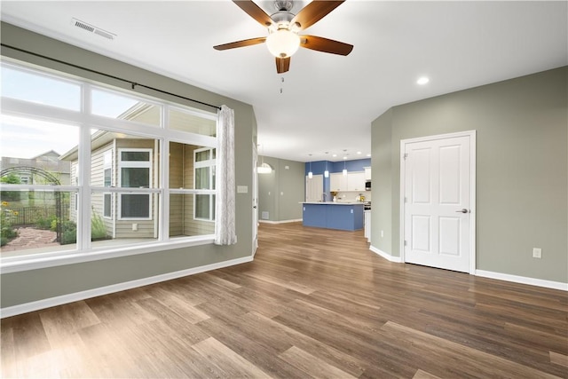 unfurnished living room featuring wood-type flooring and ceiling fan