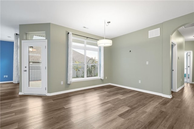 unfurnished dining area featuring dark hardwood / wood-style floors