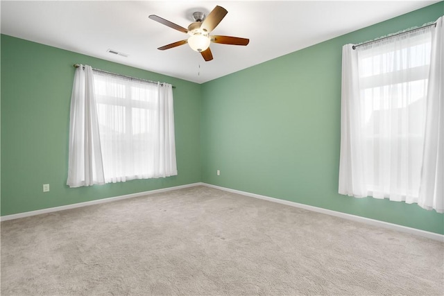 unfurnished room with light carpet and ceiling fan