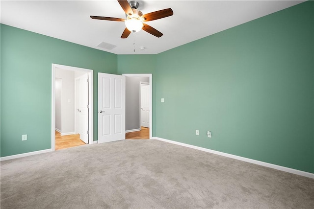 unfurnished bedroom with light colored carpet and ceiling fan