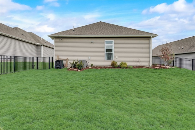 rear view of house with a yard