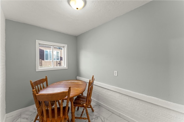 dining room featuring a textured ceiling