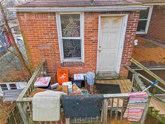 view of exterior entry featuring a wooden deck