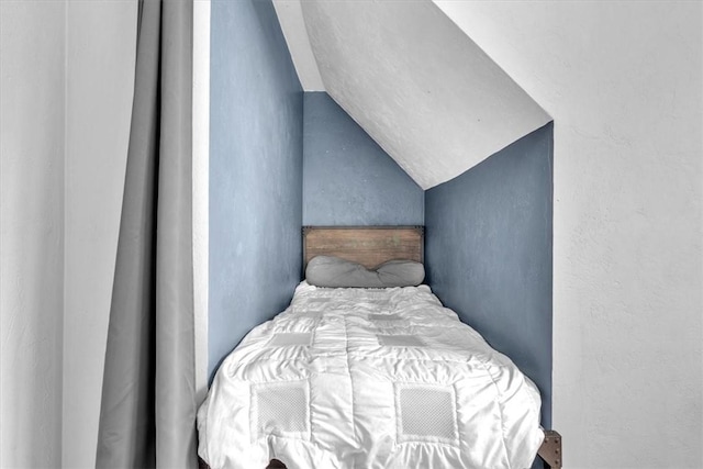 bedroom featuring lofted ceiling