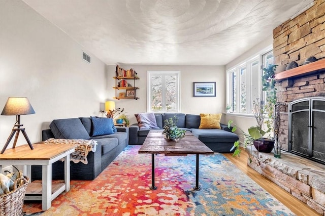 living room with a fireplace and wood-type flooring