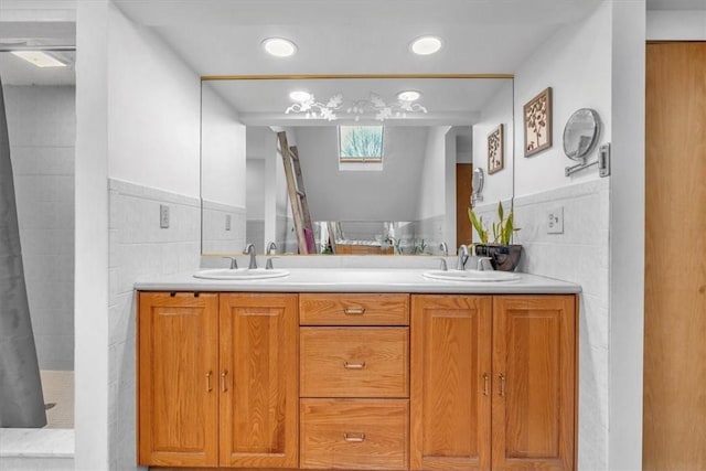 bathroom featuring vanity, tile walls, and walk in shower