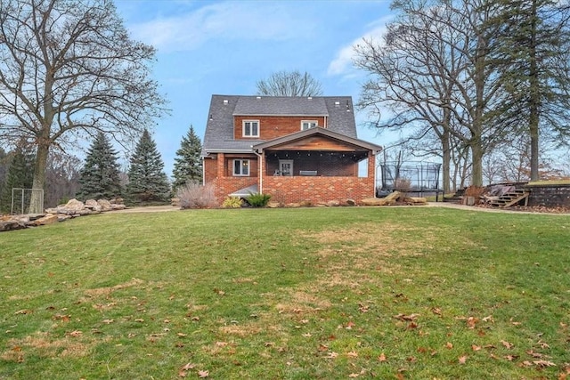 rear view of property featuring a yard