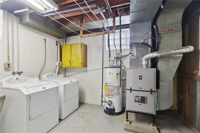 clothes washing area with water heater and washer and dryer