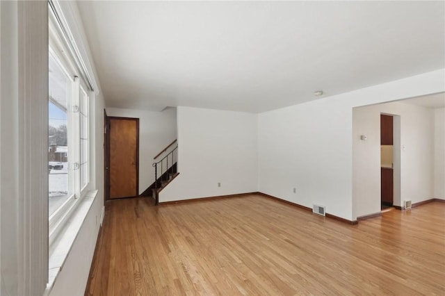 unfurnished living room with light hardwood / wood-style flooring