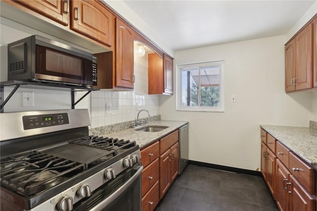 kitchen with tasteful backsplash, light stone countertops, sink, and stainless steel appliances