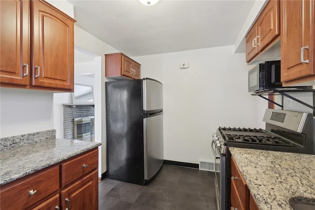 kitchen featuring light stone countertops and appliances with stainless steel finishes