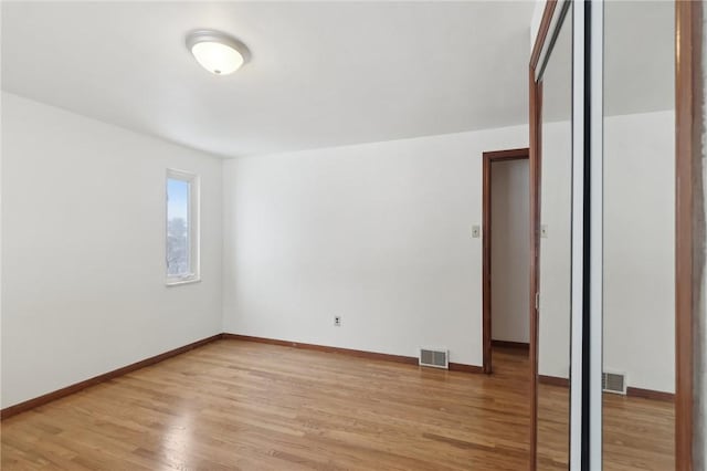 spare room featuring light hardwood / wood-style floors