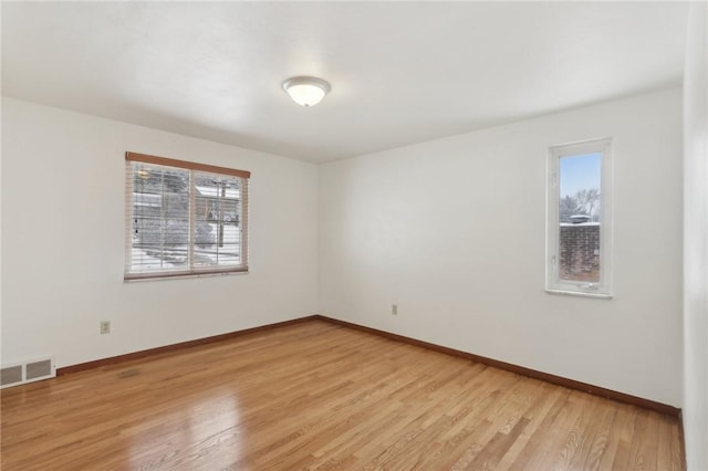 empty room with light hardwood / wood-style floors