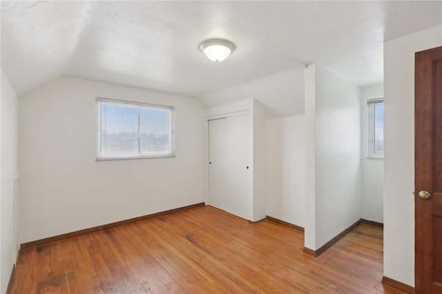 bonus room featuring hardwood / wood-style flooring and vaulted ceiling