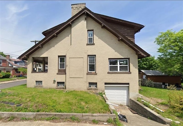 view of side of home with a yard and a garage