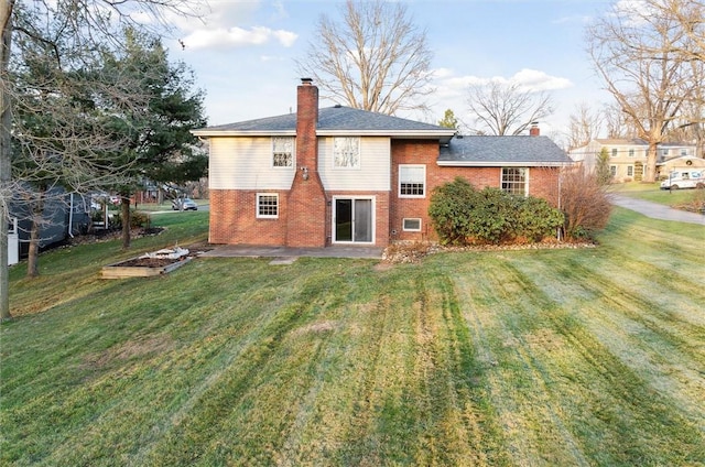 rear view of house with a patio area and a yard