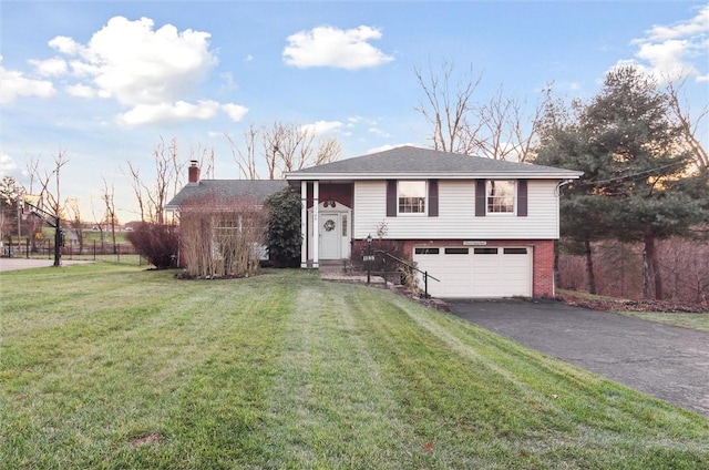 raised ranch featuring a lawn and a garage