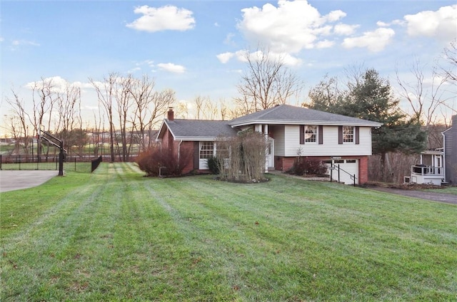 view of front facade with a yard and a garage