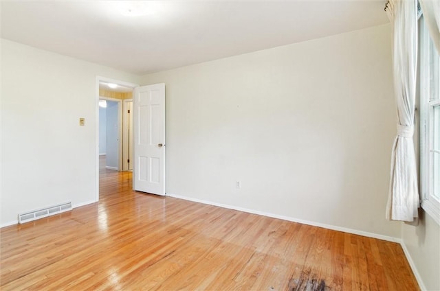 spare room featuring light hardwood / wood-style flooring