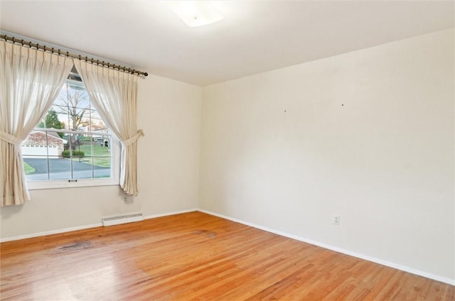 empty room featuring wood-type flooring and plenty of natural light