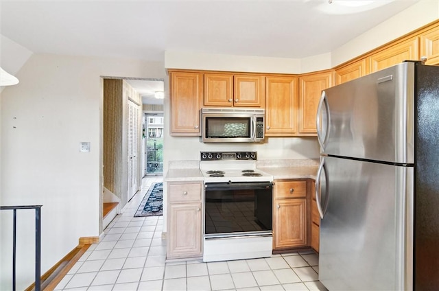 kitchen with appliances with stainless steel finishes and light tile patterned floors