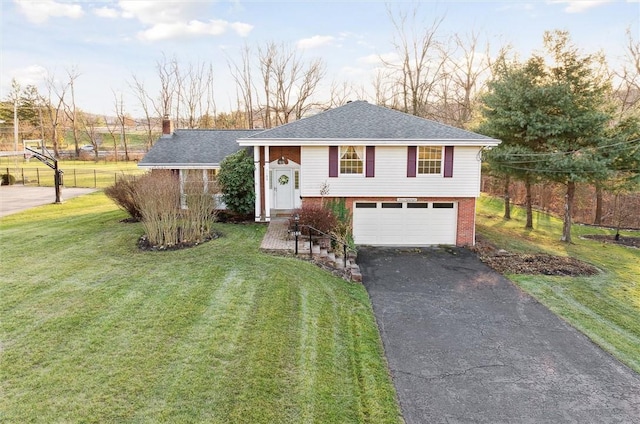 split foyer home with a front yard and a garage