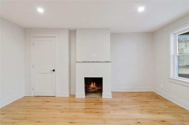 unfurnished living room with light hardwood / wood-style flooring