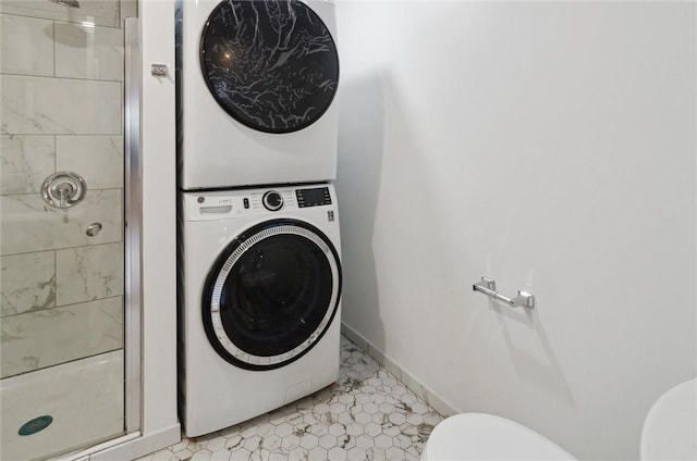 laundry room with light tile patterned floors and stacked washer and clothes dryer