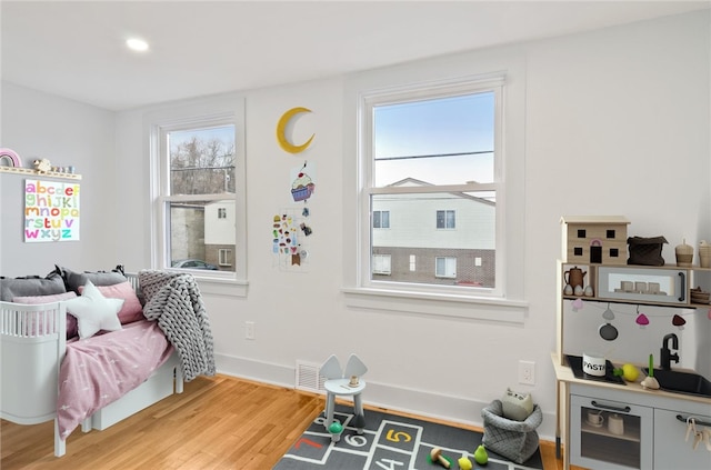 game room with hardwood / wood-style floors