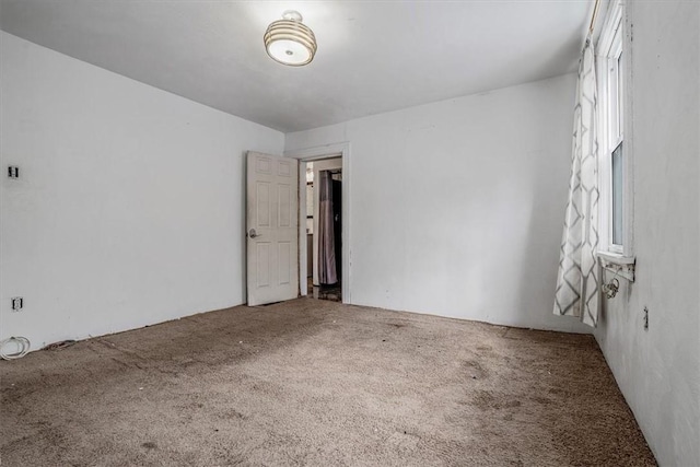 unfurnished room featuring carpet