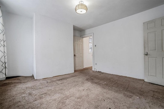 unfurnished room featuring carpet