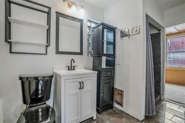 bathroom with curtained shower and vanity