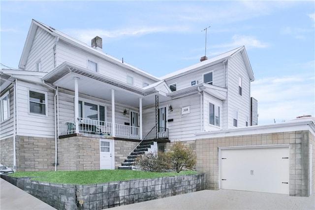 view of front of home featuring covered porch and a garage