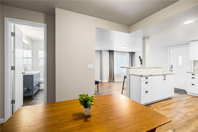 dining room with light hardwood / wood-style flooring and sink