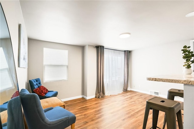 living area with light hardwood / wood-style flooring