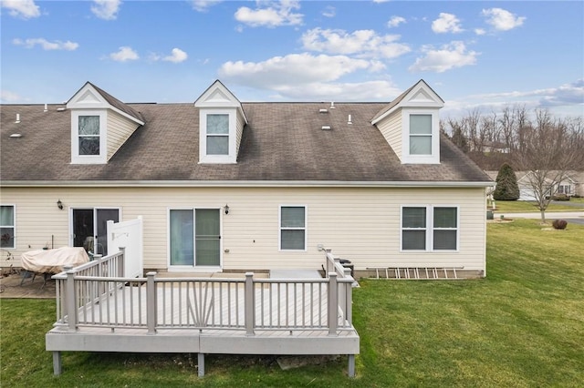 back of property featuring a lawn and a wooden deck