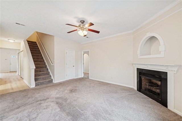 unfurnished living room featuring carpet, ceiling fan, and ornamental molding