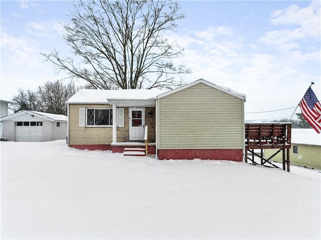 view of front of property with a garage and an outbuilding